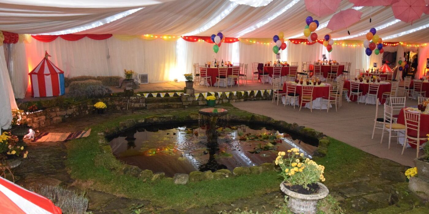 Garden pond and flower beds inside the circus marquee - 12m Frame Marquee