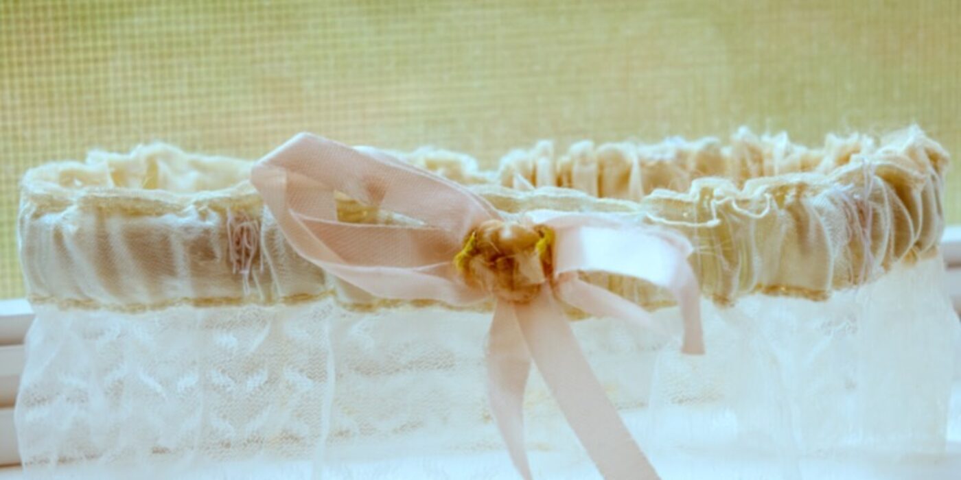 a-brides-garter-sits-in-a-windowsill-on-her-wedding-day